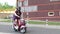 Express food delivery service. Delivery boy wearing red uniform on scooter with isothermal food case box