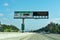 Express lanes marked by overhead signage, and smaller HOV sign located in the median on highway. The toll amount is posted on an