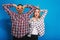 Expressing brightful positive emotions of funny excited couple having fun on blue background. Fooling around, free time