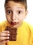 Expressive child eating chocolate