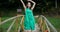 Expressive dance of a young and beautiful girl on a wooden bridge.