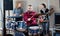 Expressive drummer with his bandmates practicing in rehearsal room