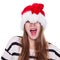 Expressive emotional girl in a Christmas hat on white background