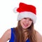 Expressive emotional girl in a Christmas hat on white background