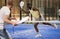 Expressive energetic aframerican man playing padel indoors