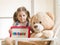 Expressive little girl holding a magnetic board