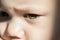 Expressive look of a small child. Baby\'s eye close-up. Gray green iris