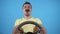 Expressive man with a mustache behind the wheel on a blue background slow mo, isolate