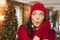 Expressive Mixed Race Girl Wearing Mittens and Hat In Christmas Setting