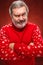 The expressive portrait on red background of a pouter man