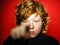 Expressive red-haired teenage boy showing emotions in studio