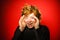 Expressive red-haired teenage boy showing emotions in studio