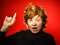 Expressive red-haired teenage boy showing emotions in studio