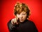 Expressive red-haired teenage boy showing emotions in studio