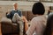 Expressive short-haired man asking for advice while having appointment