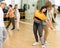 Expressive teen brunette practicing dynamic boogie-woogie in pair with boy