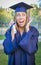 Expressive Teen Woman Holding Diploma in Cap and Gown