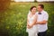 Expressive wedding couple on the meadow during outdoor photosession