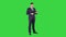 Expressive young businessman with tablet presenting something swiping on a Green Screen, Chroma Key.