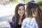 Expressive Young Mixed Race Female Sitting and Talking with Girl