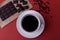 Expresso coffee in a white cup on a red background, close-up