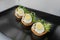 Exquisite appetizers from chef. Close-up of tartlet with quail egg, cheese and chicken