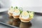 Exquisite appetizers from chef. Close-up of tartlet with quail egg and chicken and microgreens