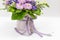 Exquisite bouquet white, lilac, green blue, lime, purple in a small gift cardboard box on a light background