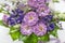 Exquisite bouquet white, lilac, green blue, lime, purple in a small gift cardboard box on a light background