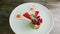 Exquisite decorated raspberry dessert spin around on white plate