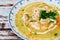 Exquisite dish with a homemade cream of poultry soup with chicken pieces, parsley and cream on a rustic or country style wooden