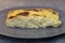 Exquisite egg and cheese casserole on a grey plate