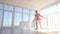 Exquisite female ballet dancer in pink tutu practicing and smiling