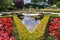 Exquisite fountain among the flower beds