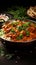 Exquisite fusion Indian butter chicken in black bowl on rustic wooden table