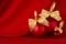 Exquisite glossy balls with golden bow on elegant dark silk backdrop with smooth waves, copy space, closeup. Rich christmas.