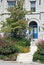 Exquisite Landscaping With Stone Stairs and Blue Door
