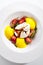 Exquisite serving burrata cheese with tomatoes and mango mousse top view