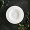 Exquisite serving white restaurant plate template on natural dark stone and leaves background