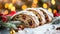 Exquisite stollen bread close up on white tabletop with glistening frosting layer