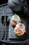 Exquisite sushi burger with shrimps and fish on strone plate