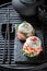 Exquisite sushi burger with vegetables and seafood on strone plate