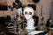 Exquisite table arrangement featuring champagne glasses and a white marble bust of a Greek goddess