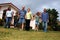 Extended family in front of home