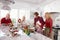 Extended Family Group Preparing Christmas Meal In Kitchen