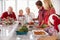 Extended Family Group Preparing Christmas Meal In Kitchen