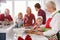 Extended Family Group Preparing Christmas Meal In Kitchen