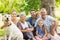 Extended family with their pet dog at park