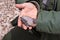 Extended hand holds rock of petrified wood