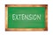 EXTENSION text written on green school board